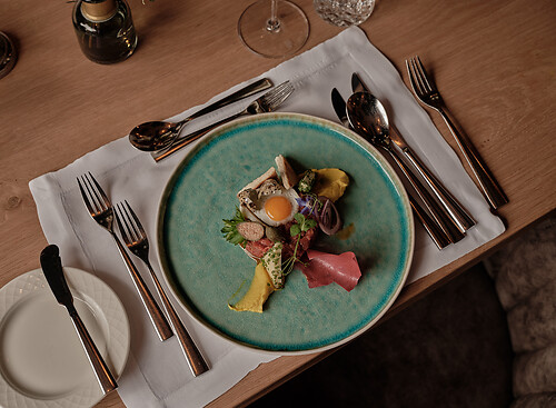 Beef tartar on a green plate with fried egg in Restaurant Grossarl