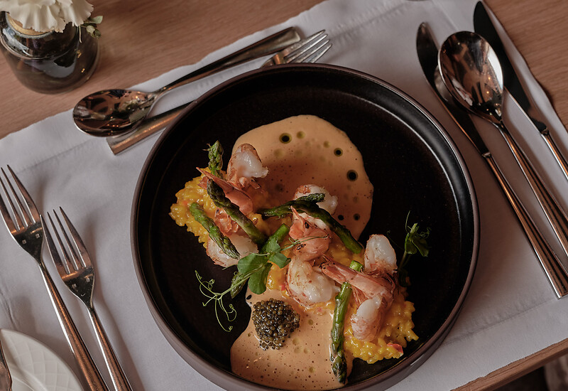 Shrimp risotto on black plate from Salzburg restaurant