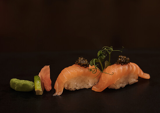 Sushi on a black plate with wasabi in sushi restaurant austria