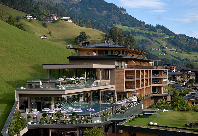 Wellness Spa hotel Austria from outside in summer with outdoor pool, infinity pool, adults only