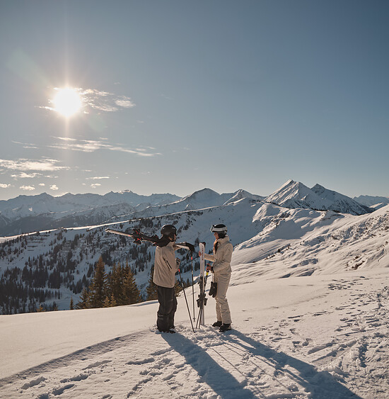 Sun skiing in the luxuary ski resort austria with Ski In Ski Out in sunny snowy landscape